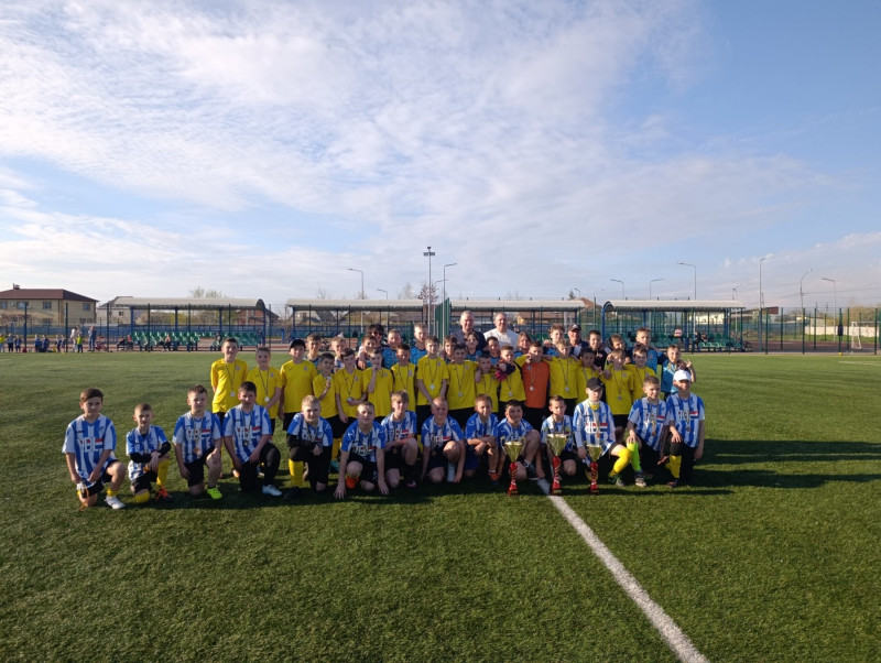 Команди разом стоять на полі. Діти з медалями, кубками. Разом із дітьми - міський голова, тренери, організатори турніру.